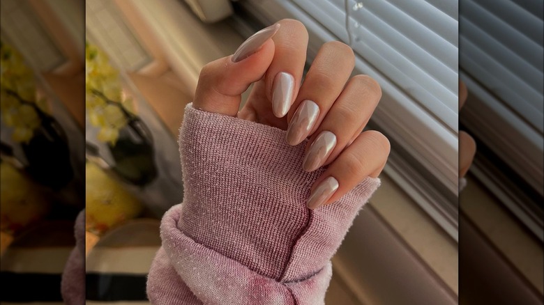 Hand showing nude nails with chrome finish