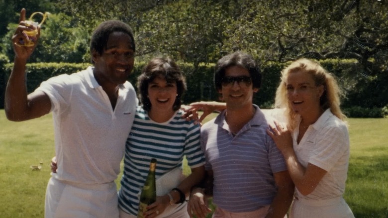 O.J. Simpson, Kris Jenner, RObert Kardashian, and Nicole Brown Simpson smiling