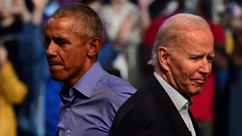 Joe Biden and Barack Obama with unhappy expressions on their faces