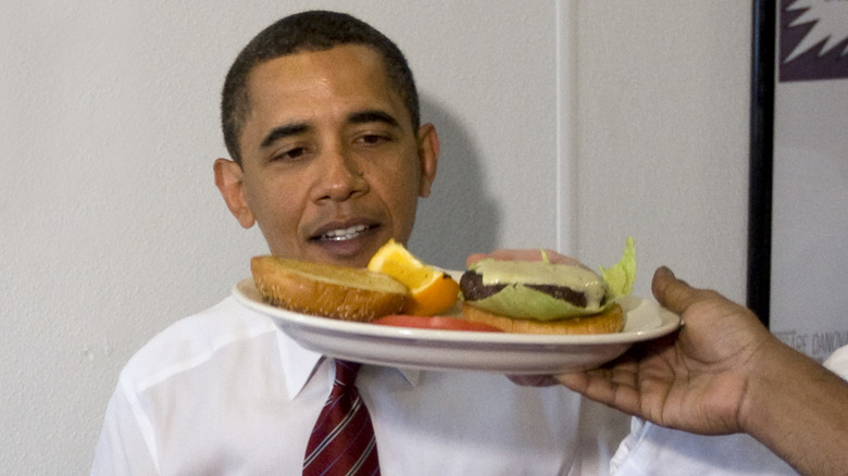 Barack Obama being served hamburger