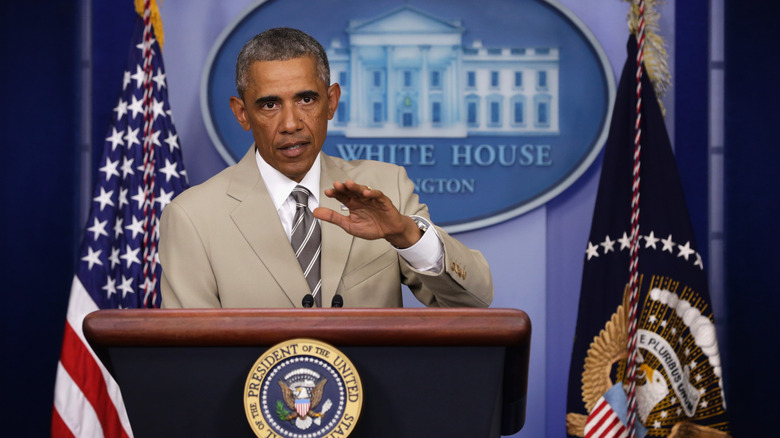 Barack Obama speaking in a tan suit