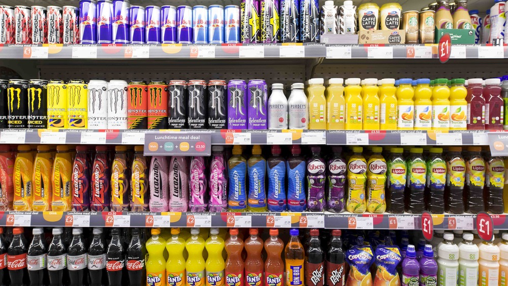 A store shelf full of energy drinks and sodas