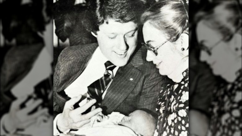 Bill and Hillary Clinton holding Chelsea 