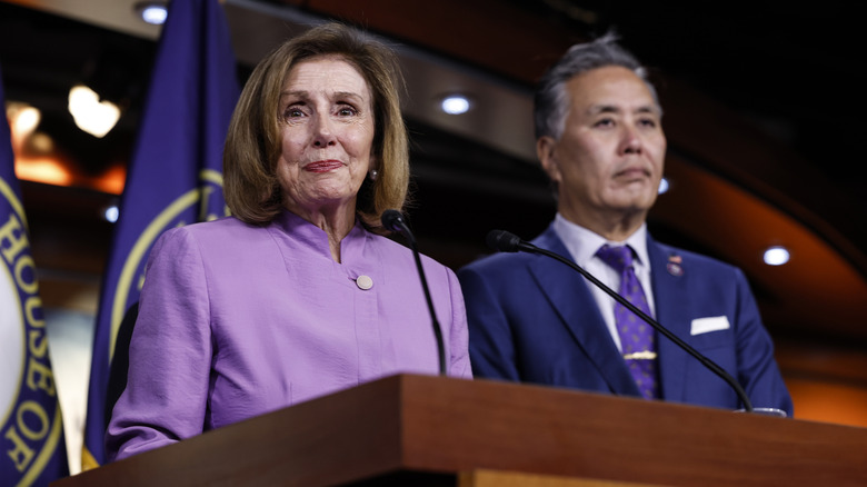 Nancy Pelosi standing at podium