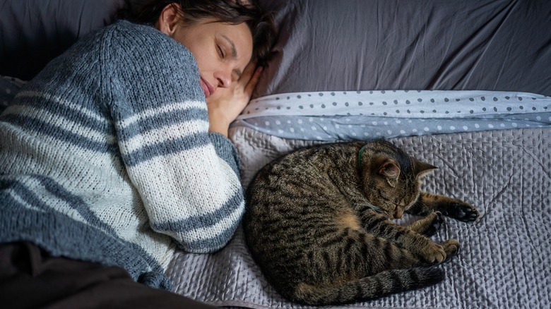 Cat and woman sleeping