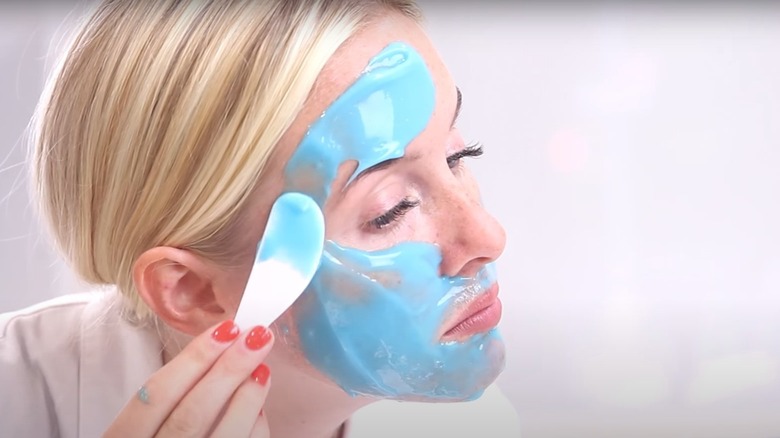 woman applying face mask