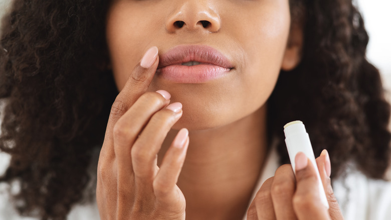 woman using lip product 