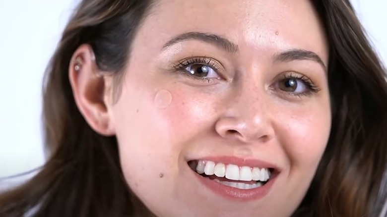 Woman wearing pimple patch