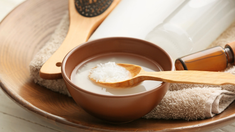 Rice water in a bowl with brushes and a towel