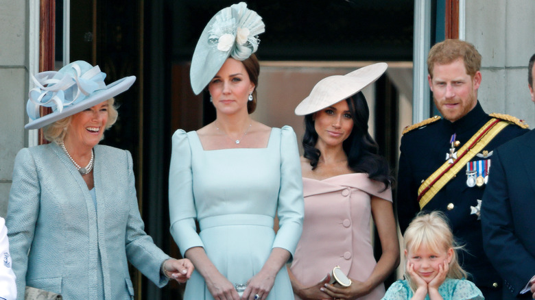 Camilla Parker Bowles, Kate Middleton, Meghan Markle, and Prince Harry standing