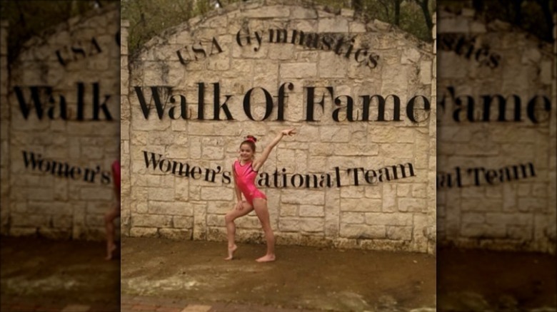 Young Olivia Dunne in pink gymnastics leotard