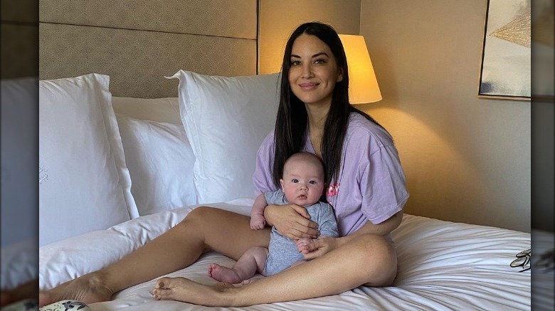 Olivia Munn posing for a photo with her baby Malcolm 