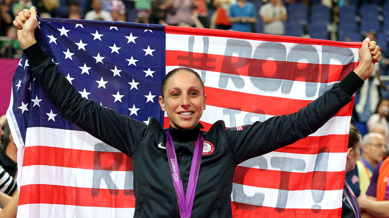 Olympian Diana Taurasi poses with an American flag