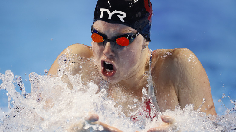 Lilly King wears googles while swimming.