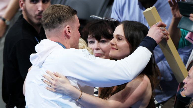 Adam Peaty hugging Holly Ramsay at the Olympics