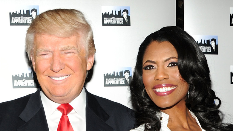 Donald Trump and Omarosa pose at an event