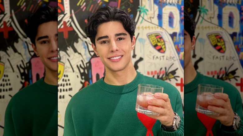 Omid Scobie holding drink smiling