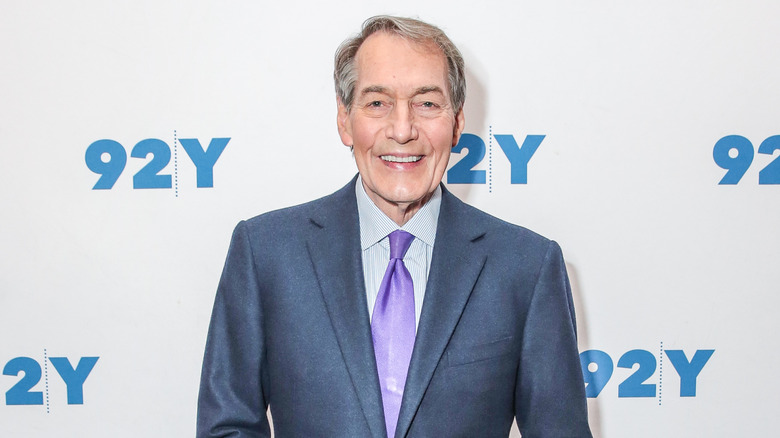 Charlie Rose smiling in a suit 