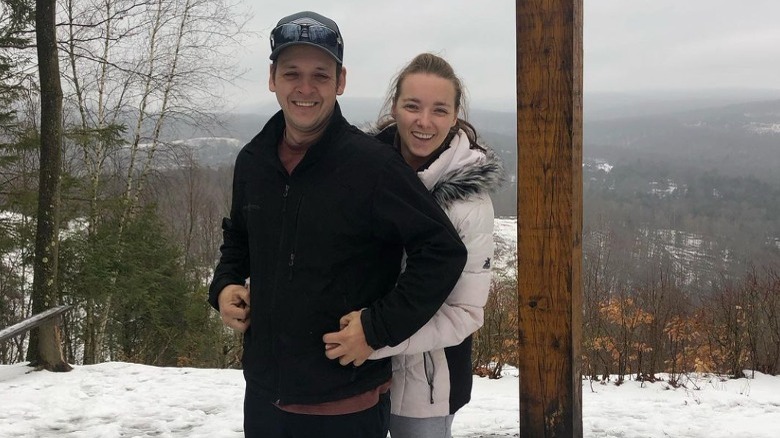 Abe and Rebecca Schmucker posing outside in snow