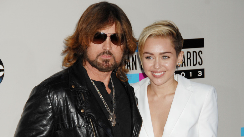 Billy Ray and Miley Cyrus posing