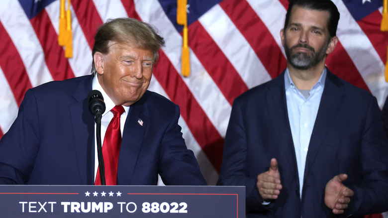 Don Jr. claps while his father smiles