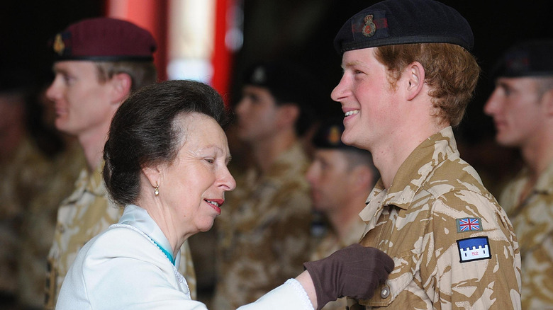 Princess Anne pinning medal to Prince Harry