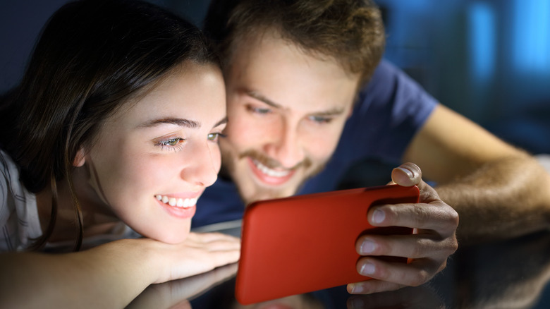 Woman and man looking at phone