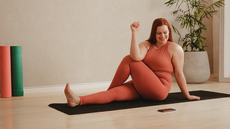 woman practicing yoga with an app