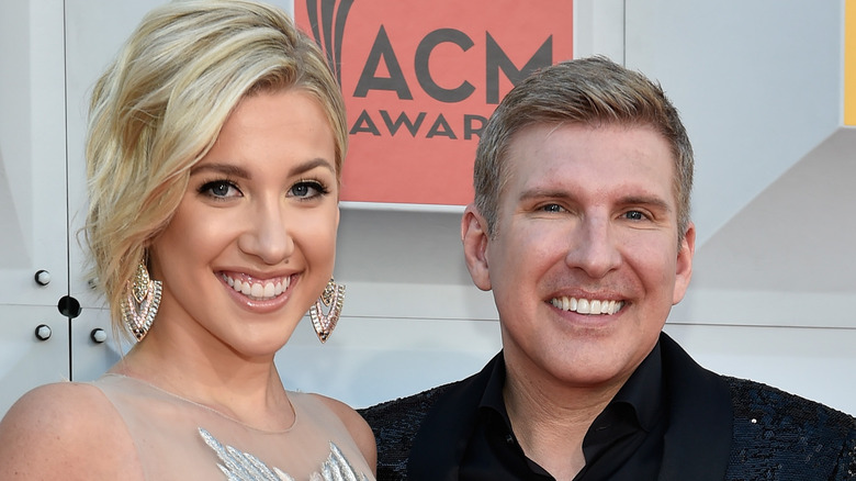 Savannah and Todd Chrisley pose together at an event