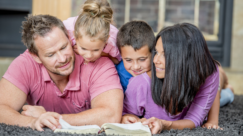 Family looking at bible