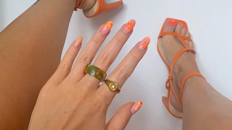 Orange manicure and pedicure