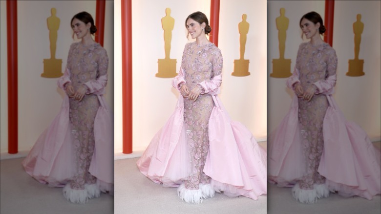 Allison Williams posing on champagne Oscars carpet