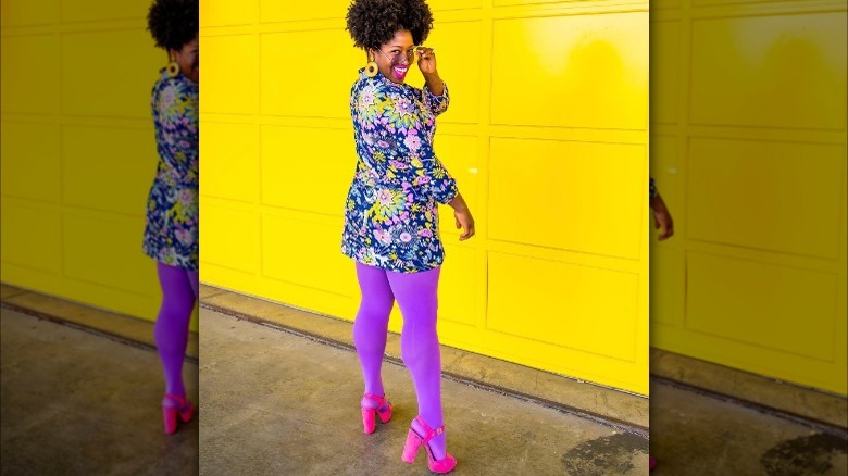 woman wearing purple tights, pink heels and floral dress