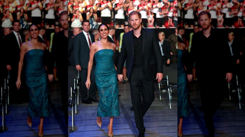 Prince Harry and Meghan Markle walking in arena