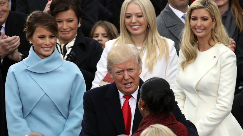 Melania, Donald, and Ivanka Trump at an event 