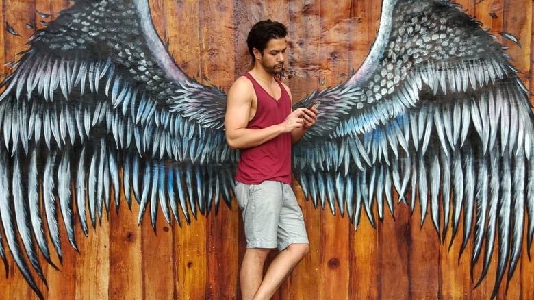 Marco Grazzini leaning on winged wall