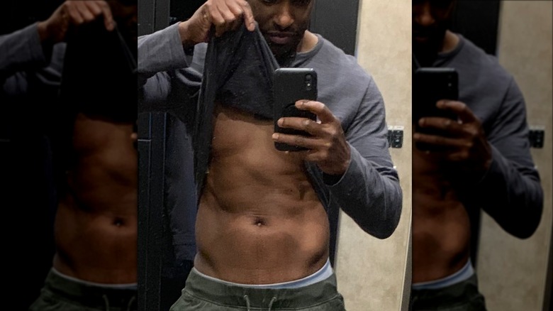 Colin Lawrence taking shirt-lifted mirror selfie 