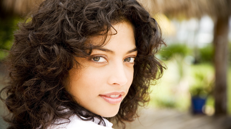 person with shoulder-length curly hair