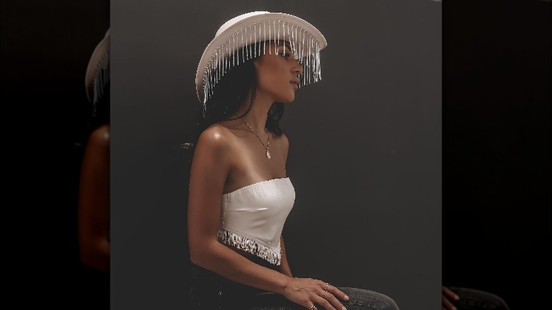 Woman wearing rhinestone cowgirl hat