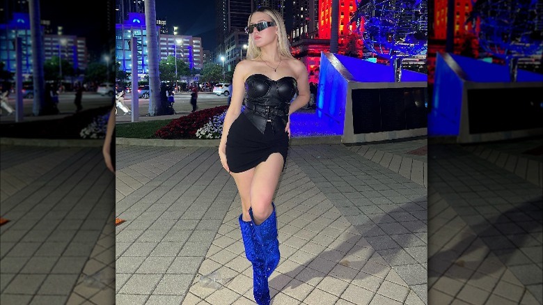 Woman wears bright blue bedazzled boots