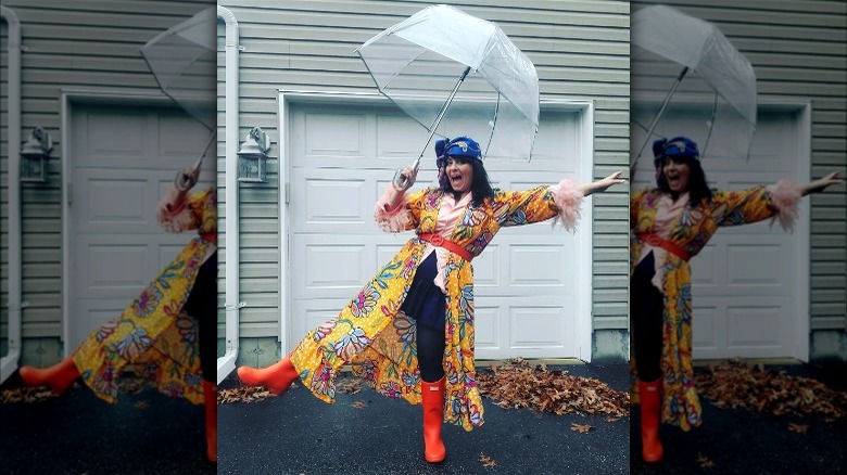 Brunette with umbrella in colorful outfit 