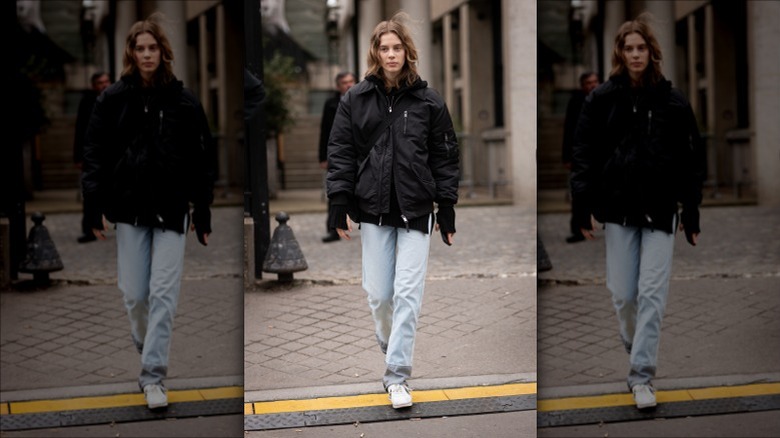 Woman walking on sidewalk