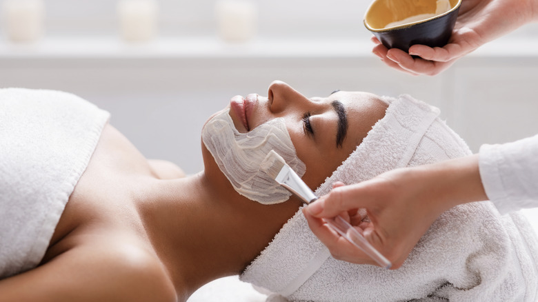 Woman receives a facial at a spa