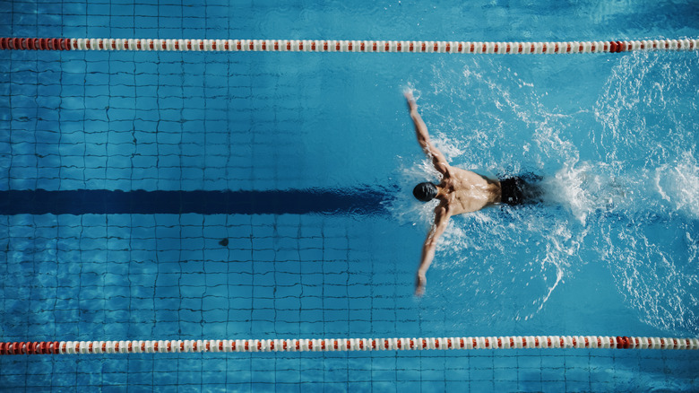 Person swims in a large pool