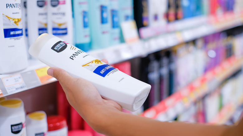 Shopper holds Pantene shampoo