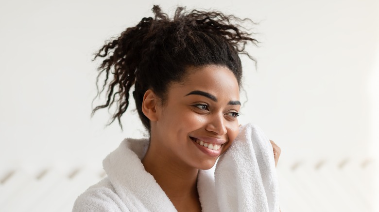 woman smiling and drying face