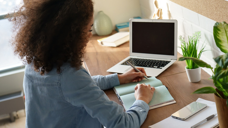 Woman writing in a journal