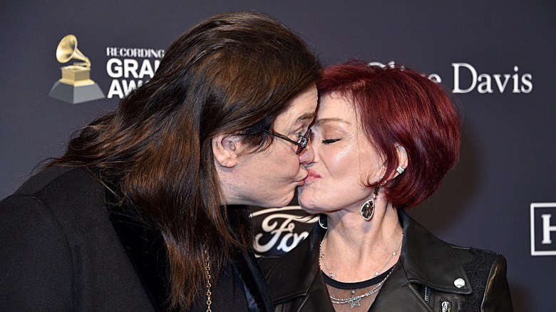 Sharon Osbourne and Ozzy Osbourne kissing