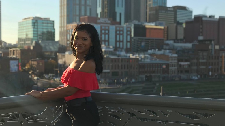 Zaire Kizito smiles against a skyline 