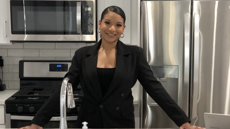 Zaire Kizito poses in kitchen 